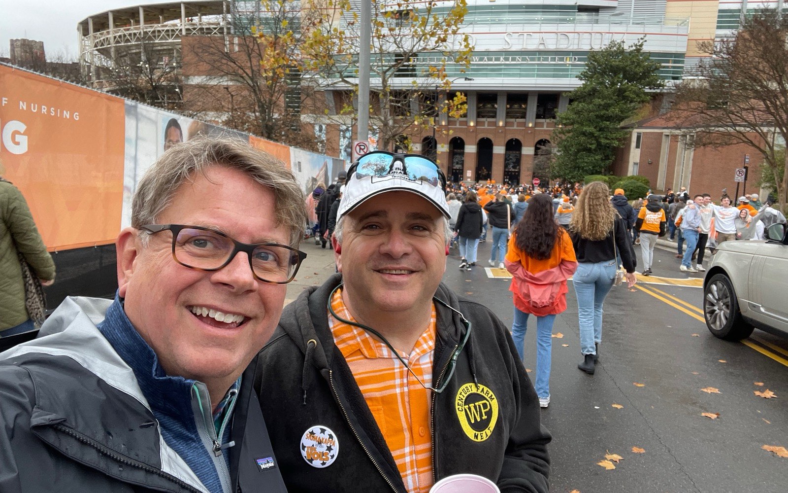 Whitt Shuford, right, outside Neyland Stadium on a Tennessee football game day, in a Whitt's Place jacket