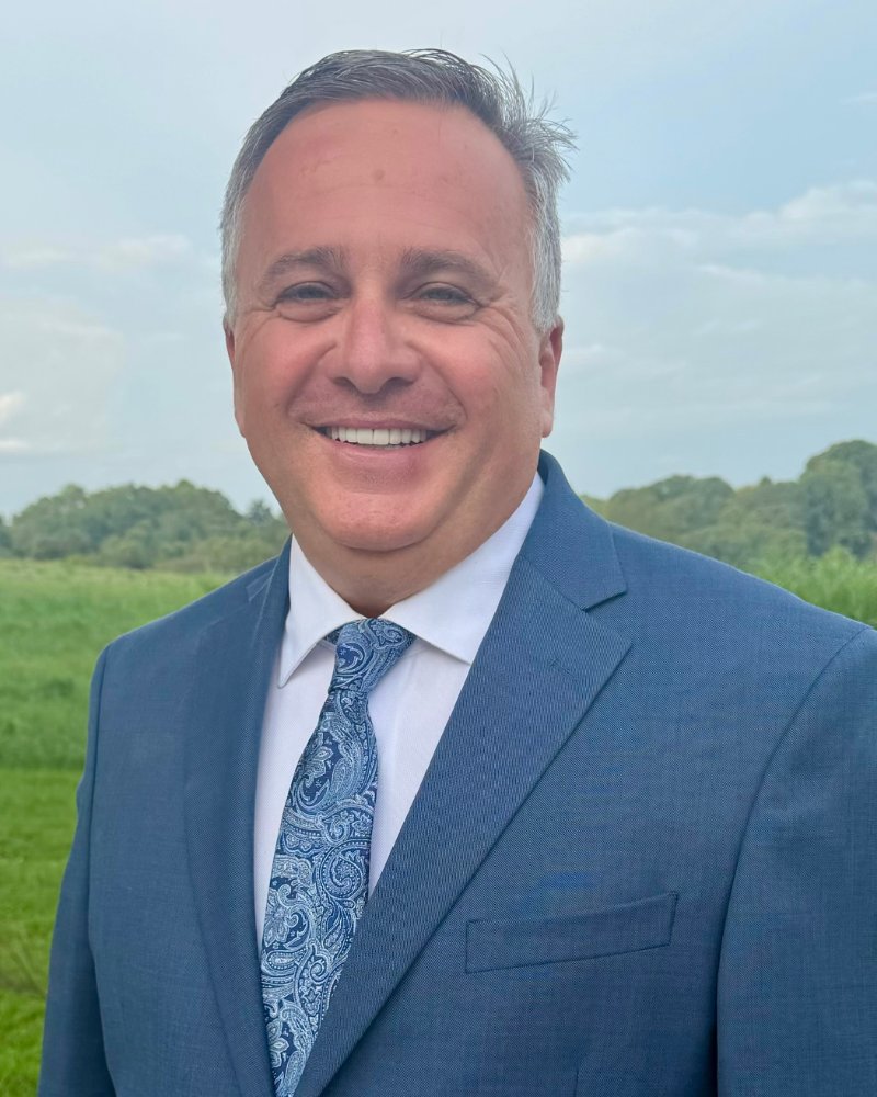 Whitt Shuford, candidate for Claiborne County Mayor, standing in a pasture